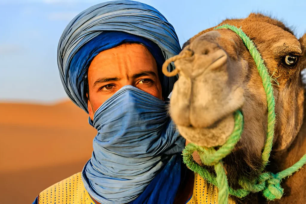Berber guide with camel in the Sahara Desert at sunset – Morocco Pathfinder cultural desert tours